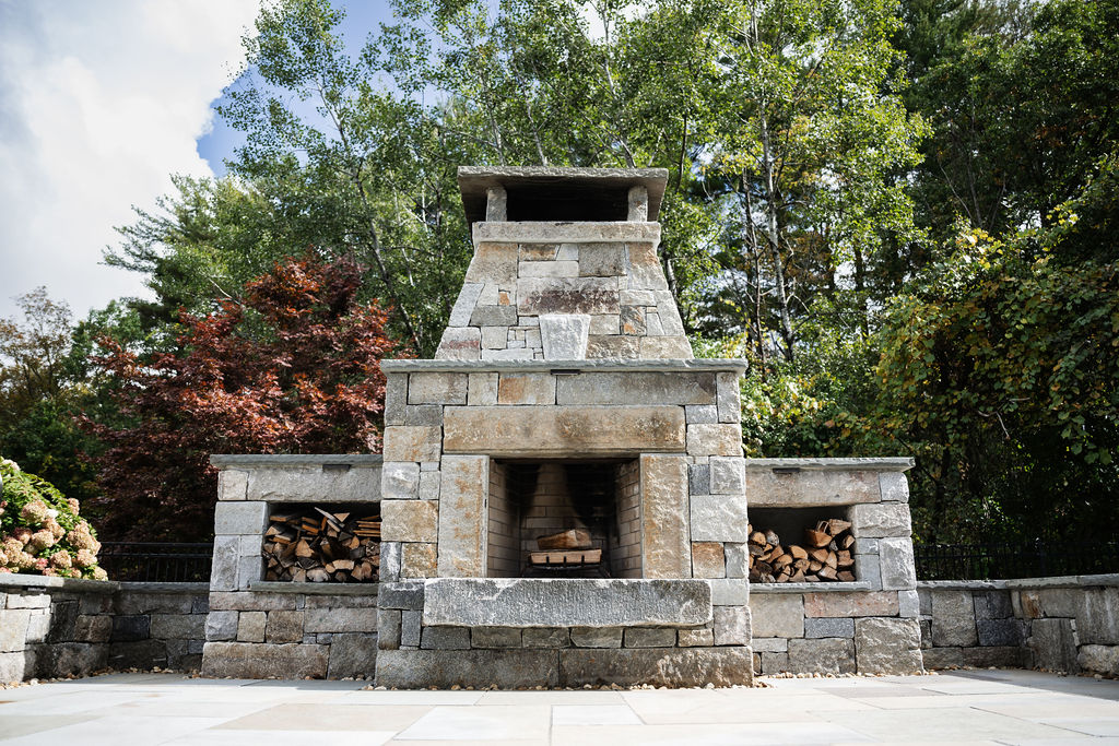 Why Choose Us - Reclaimed Granite Fireplace outdoor stone patio with fireplace and stair lighting